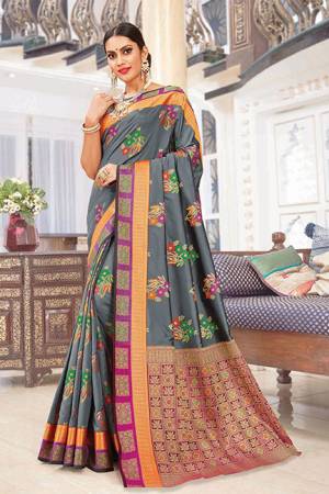 Rich And Elegant Looking Designer Silk Based Saree Is Here In Grey Color Paired With Multi Colored Blouse. It Is Beautified With Print And Weave. Buy Now.