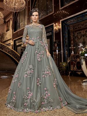 Flaunt Your Rich And Elegant Taste Wearing This Heavy Designer Floor Length Suit In Grey Color. Its Floor Length Top IS Net Based Beautified With Attractive Contrasting Embroidery Paired With Santoon Bottom And Net Fabricated Dupatta. 
