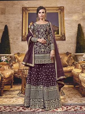 Grab This Very Beautiful Heavy Plazzo Suit In Wine Color Paired With Wine Colored Bottom And Dupatta. Its Top, Bottom And Dupatta Are Fabricated On Net Beautified With Heavy Embroidery. 