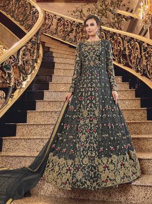 Wear This Heavy Designer suit In Two Looks With This Beautiful Dark Grey Colored Floor Length Suit Paired With A Net Fabricated Embroidered Jacket, Art Silk Fabricated Bottom And Net Fabricated Dupatta. You Can Wear This With Or Without Jacket As Per The Ocaasion. 