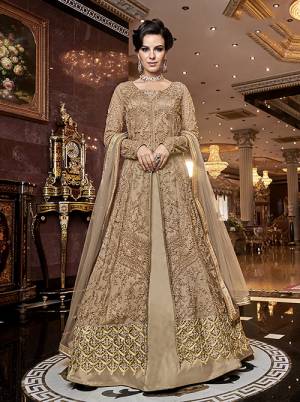 Rich And Elegant Looking Designer Indo-Western Suit Is Here In Beige Which Comes With Two Bottoms. Its Heavy Embroidered Top Is Fabricated On Net Paired With Satin Fabricated Embroidered Bottom , A Satin Fabricated Lehenga And Net Fabricated Dupatta. All Its Fabrics Are Light Weight And Easy To Carry Throughout The Gala.