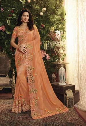 Shine Bright Wearing This Heavy Designer Saree In Orange Color Paired With Orange Colored Blouse. This Saree Is Fabricated On Tissue And Net Paired With Art Silk Fabricated Blouse. It Is Beautified With Heavy Embroidery, Buy Now.