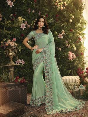 Lovely Shade Is Here To Add Into Your Wardrobe With This Heavy Designer Saree In Mint Green Color. This Saree Is Fabricated On Tissue And Net Paired With Art Silk Fabricated Blouse. Both Are Beautified With Heavy Contrasting Embroidery. 