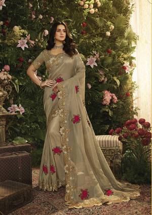 New And Unique Shade In English Color Is Here With This Elegant Looking Sand Grey Colored Saree Paired With Sand Grey Colored Blouse. This Saree Is Fabricated On Tissue Beautified With Contrasting Work Paired With Art Silk Fabricated Blouse. 