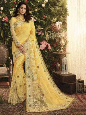 Celebrate This Festive And Wedding Season Wearing This Beautiful Yellow Colored Saree Paired With Yellow Colored Blouse. This Pretty Saree And Blouse Are Fabricated On Art Silk And Net Beautified With Pretty Work. 