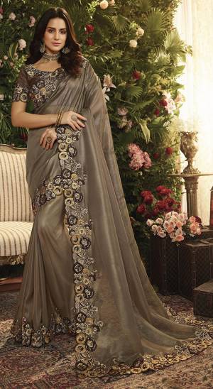 For A Bold And Beautiful Look, Grab This Heavy Designer Saree In Dark Grey Color Paired With Dark Brown Colored Blouse. This Saree Is Fabricated On Orgenza Paired With Art Silk Fabricated Blouse. It Is Beautified With Heavy Embroidered Lace Border. 
