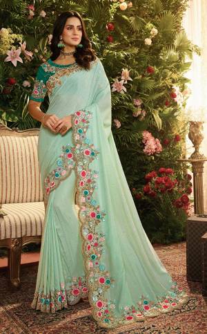 Grab This Very Beautiful And Elegant Looking Heavy Designer Saree In Turquoise Blue Color Paired With Contrasting Teal Green Colored Blouse. Ths Saree Is Fabricated On Art Silk And Net Paired With Art Silk Fabricated Blouse. It Has Pretty Contrasting Embroidery Giving An Enhanced Look.