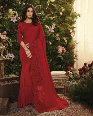Adorn The Pretty Angelic Look Wearing This Heavy Designer Saree In Red Color Paired With Red Colored Blouse. This Saree Is Fabricated On Satin Silk And Net Paired With Art Silk Fabricated Blouse. It Is Beautified With Elegant Tone To Tone Embroidery Which Will Definitely Earn You Lots Of Compliments From Onlookers. 