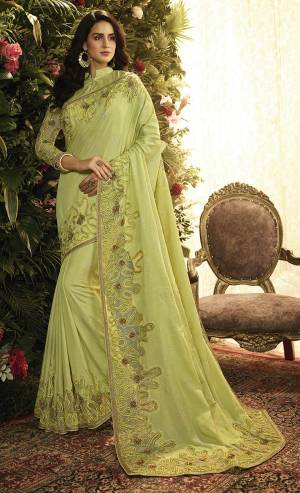 Here Is A Pretty Looking Heavy Designer Saree In Light Green Color Paired With Light Green Colored Blouse. This Saree And Blouse Are Fabricated On Art Silk And Net Beautified With Heavy Detailed Embroidery. Buy This Lovely Saree Now.