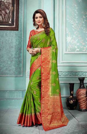 This Festive Season Be The Most Elegant In Traditional Wear With This Silk Based Saree In Green Color Paired With Contrasting Red Colored Blouse. Its Rich Fabric Is Durable, Light Weight And Easy To Care For.