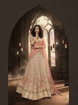 This Season Is About Subtle Shades And Pastel Play, So Grab This Heavy Designer Lehenga Choli In Pastel Pink Color Paired With Pink Colored Dupatta. It Is Beautified With Heavy Contrasting Embroidery And Jari Work. Buy This Pretty Piece Now.