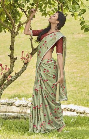 This Season Is About Subtle Shades And Pastel Play,. So Grab This Pretty Saree In Pastel Green Color Paired With Contrasting Rust Red Colored Blouse. This Saree And Blouse Are Fabricated On Mainpuri Art Silk Beautified With Floral Prints. 