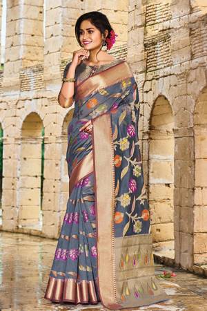 Add This Beautiful Designer Silk Based Saree To Your Wardrobe In Dark Grey Color For This Festive And Wedding Season. This Rich Silk Based Saree Will Definitely Earn You Lots Of Compliments Which Is Trending This Season. 
