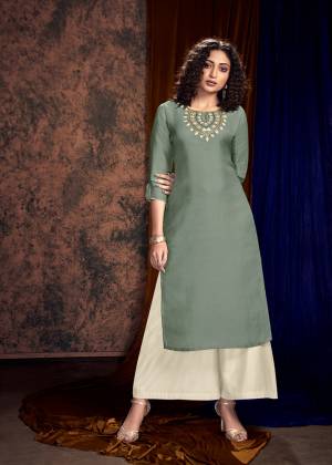 You Will Definitely Earn Lots Of Compliments Wearing This Designer Readymade Pair Of Kurti And Plazzo In Grey And Off-White Color Respectively. Its Embroidered Kurti Is Satin Silk Based Paired With Satin Cotton Fabricated Plazzo, Also It Is Available All Regular Sizes. 