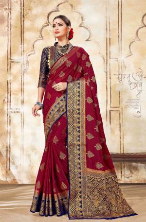 For A Royal Look, Grab This Designer Silk Based Saree In Maroon Color Paired With Contrasting Navy Blue Colored Blouse. This Saree Is Fabricated On Art Silk Paired With Jacquard Silk Fabricated Blouse. 