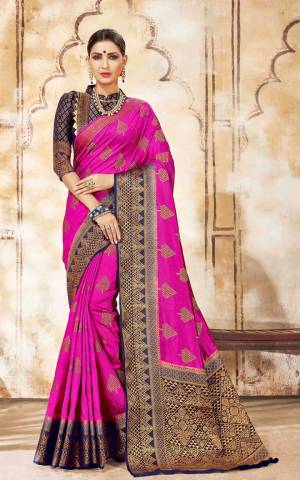 Flaunt Your Rich And Elegant Taste In This Pretty Silk Based Saree In Rani Pink Color Paired With Contrasting Navy Blue Colored Blouse. Buy This Heavy Weaved Saree Now.