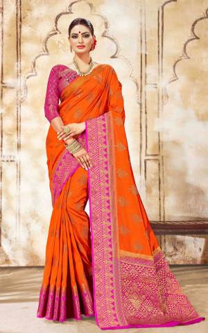Celebrate This Festive Season Wearing This Designer Saree In Orange Color Paired With Contrasting Rani Pink Colored Blouse. This Saree Is Fabricated On Art Silk Paired With Jacquard Silk Fabricated Blouse. 