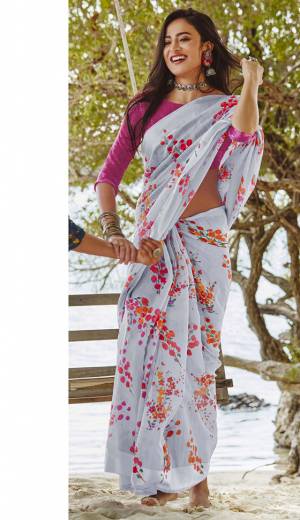 For Your Semi-Casuals, Grab This Lovely Floral Printed Saree In Pale Grey Color Paired With Rani Pink Colored Blouse. This Saree And Blouse Are Fabricated On Soft Linen Which Also Gives A Rich Look To Your Personality. 
