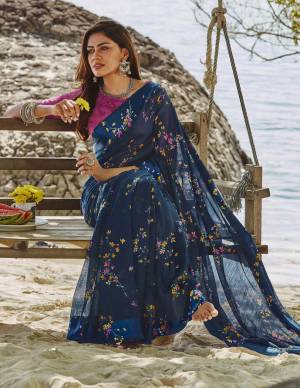 For Your Semi-Casuals, Grab This Lovely Floral Printed Saree In Navy Blue Color Paired With Rani Pink Colored Blouse. This Saree And Blouse Are Fabricated On Soft Linen Which Also Gives A Rich Look To Your Personality. 