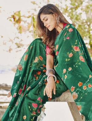 Here Is A Pretty Floral Designer Saree In Green Color Paired With Contrasting Red Colored Blouse. This Saree And Blouse Are Fabricated On Soft linen Beautified With Lovely Floral Prints All Over. 