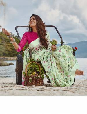 For Your Semi-Casuals, Grab This Lovely Floral Printed Saree In Pastel Green Color Paired With Rani Pink Colored Blouse. This Saree And Blouse Are Fabricated On Soft Linen Which Also Gives A Rich Look To Your Personality. 