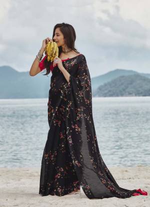 Here Is A Pretty Floral Designer Saree In Black Color Paired With Contrasting Red Colored Blouse. This Saree And Blouse Are Fabricated On Soft linen Beautified With Lovely Floral Prints All Over. 