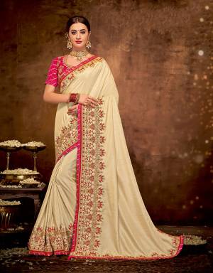 This cream saree inflenced by classical tastes is an elegant pick if you like the sheer essence of our traditions. Drape it in a half-falling pallu style and look stunning. 