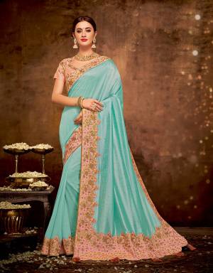 Radiate vivacious vibes and regal aura in this bright Turquoise blue saree paired with peach hues . Adorn it with maharani necklace to look glorious. 