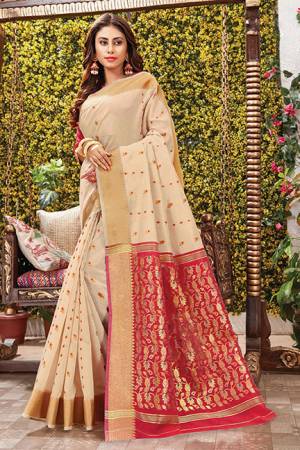 Flaunt Your Rich And Elegant Taste Wearing This Rich Silk Based Saree In Cream Color Paired With Contrasting Red Colored Blouse. This Saree Is Fabricated On Cotton Silk Paired With Art Silk Fabricated Blouse. Its Rich Color Pallete And Fabric Will Definitely Earn You Lots Of Compliments From Onlookers.