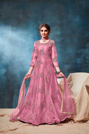 This Wedding & Festive Season, Grab This Heavy Designer Floor Length Suit In Pink Color. Its Embroidered Top Is Fabricated On Net Paired With Santoon Bottom And Net Fabricated Dupatta. Buy Now.