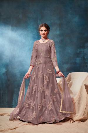 This Wedding & Festive Season, Grab This Heavy Designer Floor Length Suit In Mauve Color. Its Embroidered Top Is Fabricated On Net Paired With Santoon Bottom And Net Fabricated Dupatta. Buy Now.