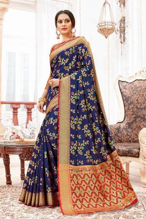 For A Proper Traditional Look, Grab This Designer Saree In Navy Blue Color Paired With Contrasting Red Colored Blouse. This Saree And Blouse Are Silk Based Which Gives A Rich Look To Your Personality. 