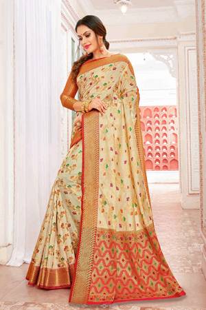 Celebrate This Festive Season With Beauty And Comfort Wearing This Designer Silk Based Saree In Cream Color Paired With Contrasting Red Colored Blouse. This Saree And Blouse Are Beautified With Weave Giving It An Attractive Look. 