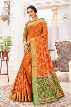 Celebrate This Festive Season With Beauty And Comfort Wearing This Designer Silk Based Saree In Orange Color Paired With Contrasting Green Colored Blouse. This Saree And Blouse Are Beautified With Weave Giving It An Attractive Look. 