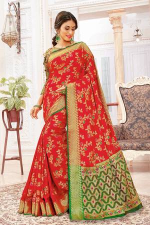 For A Proper Traditional Look, Grab This Designer Saree In Red Color Paired With Contrasting Green Colored Blouse. This Saree And Blouse Are Silk Based Which Gives A Rich Look To Your Personality. 