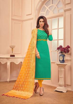 Add This Pretty Dress Material To Your Wardrobe In Sea Green Colored Top Paired With Contrasting Musturd Yellow Colored Bottom And Dupatta. Its Top And Bottom Are Fabricated On Cotton Paired With Banarasi Silk Dupatta. Buy Now.