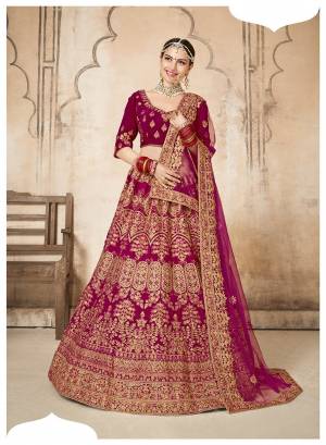Be The Most Trending Bride Wearing This Heavy Designer Lehenga Choli In All Over Dark Pink Color. This Pretty Heavy Embroidered Lehenga Choli Is Fabricated On Velvet Paired With Net Fabricated Dupatta. Buy This Lehenga Choli Now.