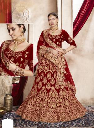 This Wedding Season, Grab This Very Beautiful Heavy Designer Lehenga Choli In Maroon Color. Its Pretty Blouse And Lehenga Are Fabricated On Velvet Paired With Net Fabricated Dupatta. It Is Beautified With Heavy Jari Embroidery And Stone Work. 
