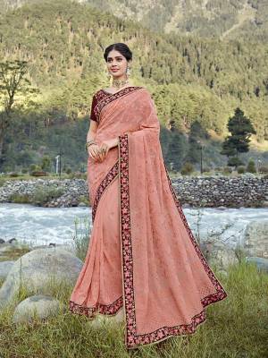 Here Is A Lovely Designer Saree In Peach Color Paired With Contrasting Maroon Colored Blouse. This Pretty Tone To Tone Embroidered Saree Is Fabricated On Georgette Paired With Art Silk Fabricated Blouse.