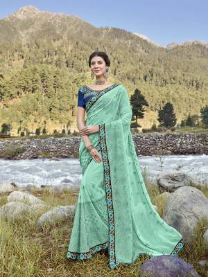 Celebrate This Festive Season Wearing This Very Pretty Designer Saree In Sea Green Color Paired With Contrasting Royal Blue Colored Blouse. This Saree IS Georgette Based Paired With Art Silk Fabricated Blouse. Buy Now.