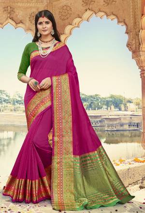 Bright And Visually Appealing Color Is Here With This Designer Saree In Rani Pink Color Paired With Contrasting Green Colored Blouse. This Saree Is Cotton Silk Based Paired With Art Silk Fabricated Blouse. Its Fabric Gives A Rich Look To Your Personality. 
