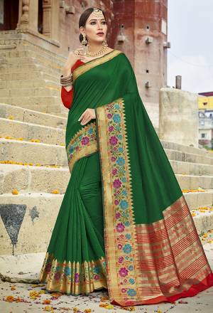 Celebrate This Festive Season With Beauty And Comfort Wearing This Saree In Green Color Paired With Red Colored Blouse. This Traditional Color Pallete In Cotton Silk Based Saree Will Earn You Lots Of Compliments From Onlookers.