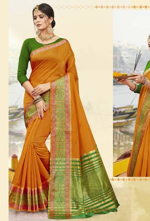 Add This Beautiful Saree To Your Wardrobe In Musturd Yellow Color Paired With Contrasting Green Colored Blouse. This Saree Is Cotton Silk Based Paired With art Silk Fabricated Blouse. Buy Now.