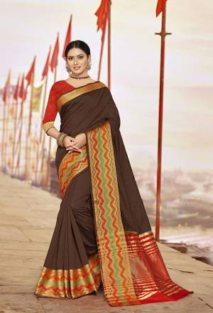 Bright And Visually Appealing Color Is Here With This Designer Saree In Brown Color Paired With Contrasting Red Colored Blouse. This Saree Is Cotton Silk Based Paired With Art Silk Fabricated Blouse. Its Fabric Gives A Rich Look To Your Personality. 