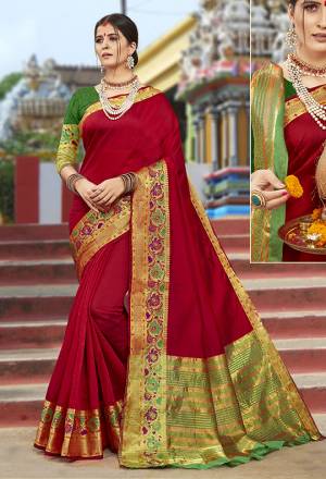 Add This Beautiful Saree To Your Wardrobe In Red Color Paired With Contrasting Green Colored Blouse. This Saree Is Cotton Silk Based Paired With art Silk Fabricated Blouse. Buy Now.