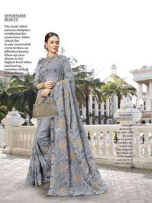 Here Is A Royal Looking Heavy Designer Saree In Grey Color. This Saree Is Georgette Based Beautified With Heavy Embroidery Paired With art silk Fabricated Blouse. Its Royal Color And Heavy Embroidery Will Earn You Lots Of Compliments From Onlookers. 