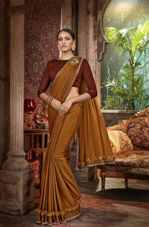 Add This Very Beautiful Designer Saree In Shades Of Brown Color. This Saree Is fabricated On Lycra Paired With Art Silk Fabricated Blouse. Its Fabric Is Light Weight, Durable And Easy To Carry Throughout The Gala.