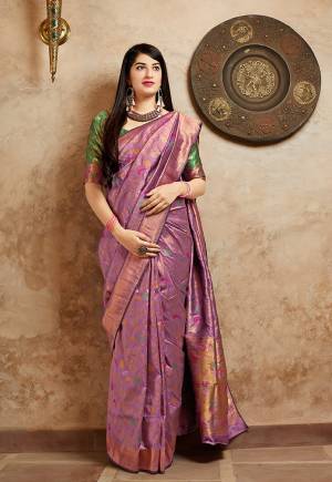 For An Elegant Pretty Look, Grab This Designer Saree In Light Purple Color Paired With Green Colored Blouse. This Saree And Blouse Are Banarasi Art Silk Based Beautified With Attractive Weave All Over. Buy Now.