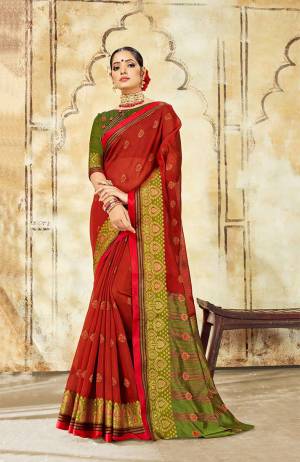 Grab This Very Beautiful Designer Saree With A Royal Silk Touch In Red Color Paired With Green Colored Blouse. This Saree Is Fabricated On Cotton Silk Paired With Art Silk Fabricated Blouse. It Has Very Elegant Heavy Weaved Border. 