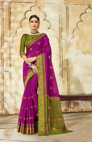 Celebrate This Festive Season With Ease And Comfort Wearing This Royal Looking Silk Based Saree In Purple Color Paired With Green Colored Blouse. This Saree Is Cotton Silk Based Paired With Art Silk Fabricated Blouse. Buy Now.